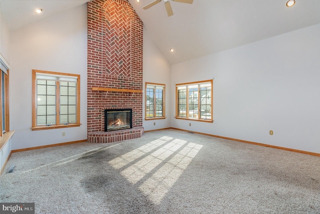 unfurnished living room featuring high vaulted ceiling, a brick fireplace, baseboards, and carpet flooring