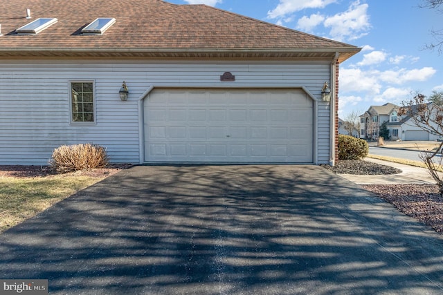 garage with aphalt driveway