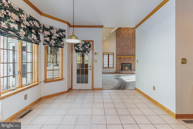 unfurnished dining area with plenty of natural light, visible vents, crown molding, and light tile patterned flooring