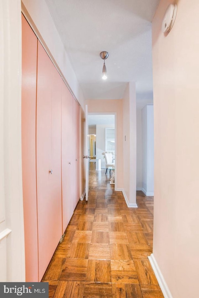 hallway featuring light parquet flooring