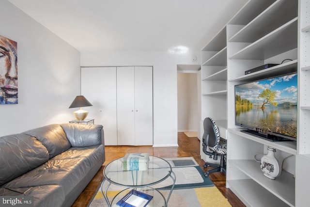 living room featuring dark parquet floors