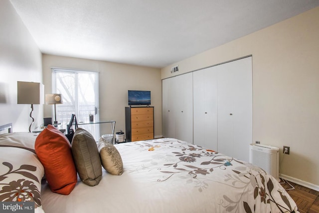 bedroom with a closet and parquet flooring