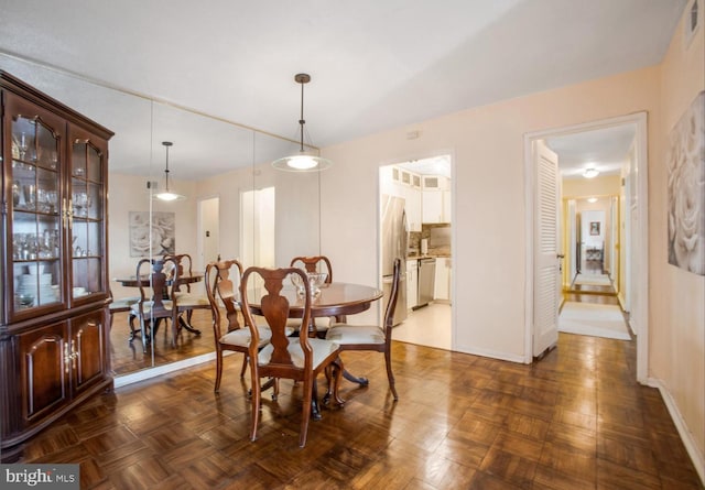 dining room featuring dark parquet flooring