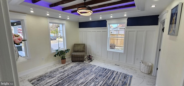 sitting room with beamed ceiling, a healthy amount of sunlight, and a raised ceiling