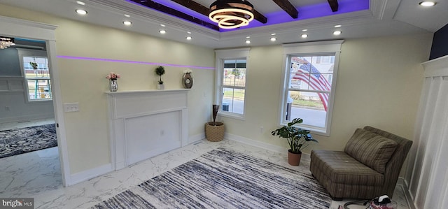 living area with a tray ceiling and ornamental molding