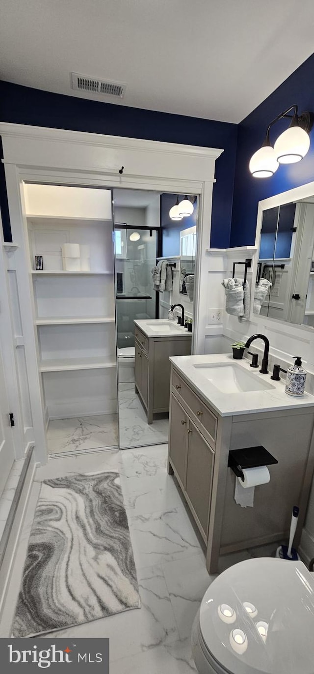 bathroom with vanity and a shower