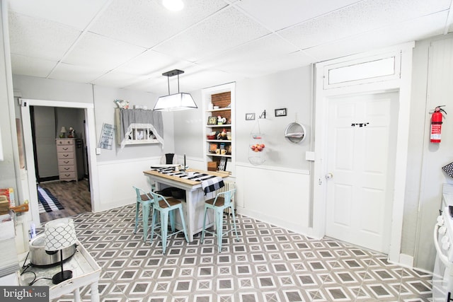 dining area featuring a drop ceiling