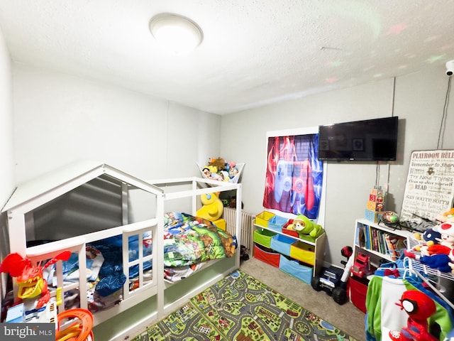 carpeted bedroom with a textured ceiling