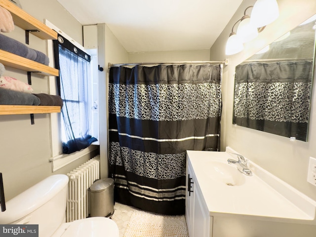 bathroom featuring toilet, walk in shower, vanity, and radiator heating unit