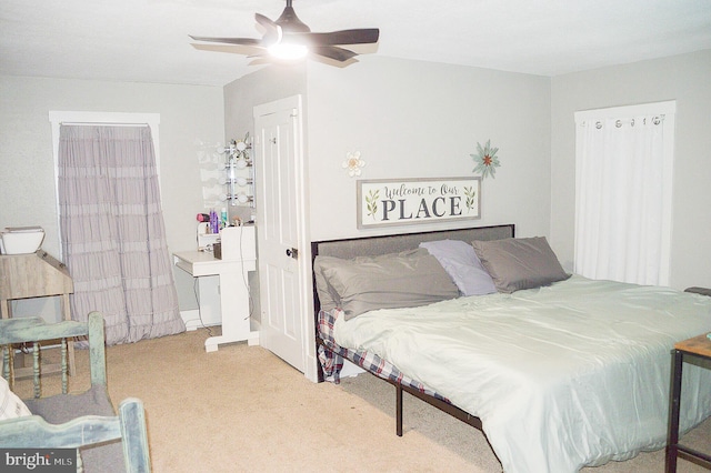 bedroom featuring light carpet and ceiling fan