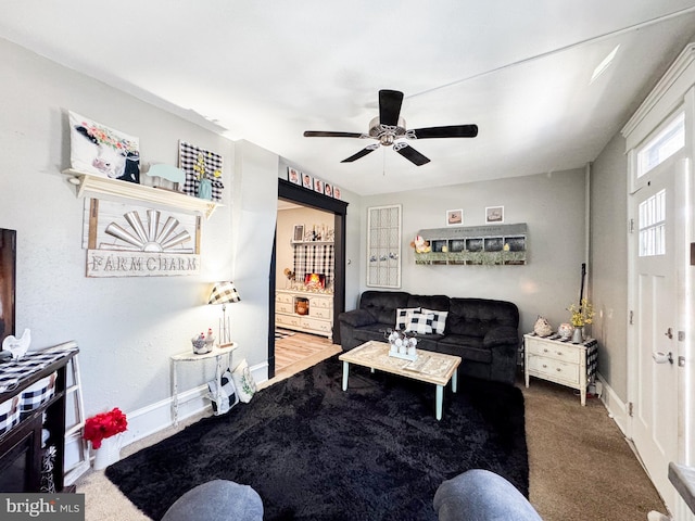 living room with ceiling fan and carpet flooring