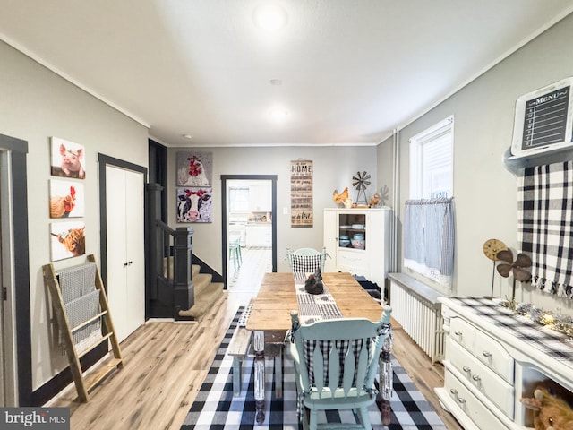 dining space featuring radiator heating unit and light hardwood / wood-style floors