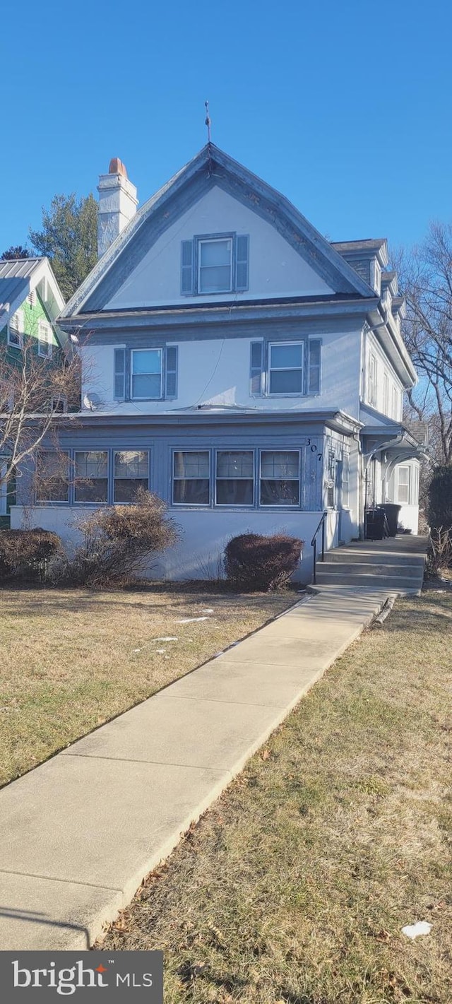 view of side of home with a lawn