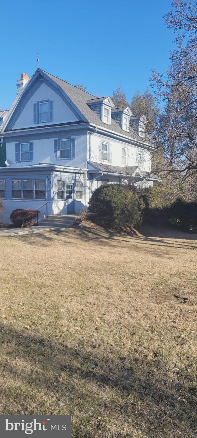 rear view of house with a lawn