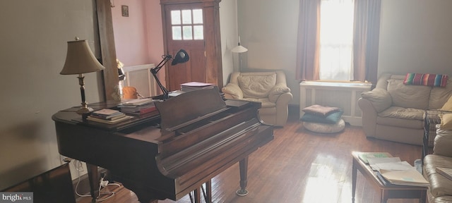 misc room featuring radiator heating unit and hardwood / wood-style flooring