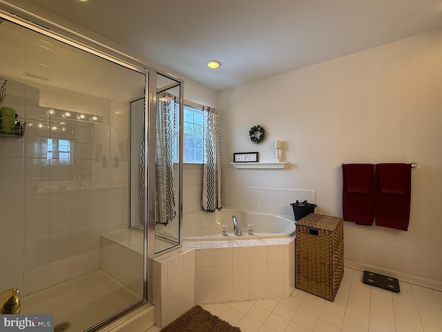 bathroom with separate shower and tub and tile patterned flooring