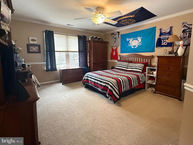 bedroom with ceiling fan, crown molding, and carpet floors