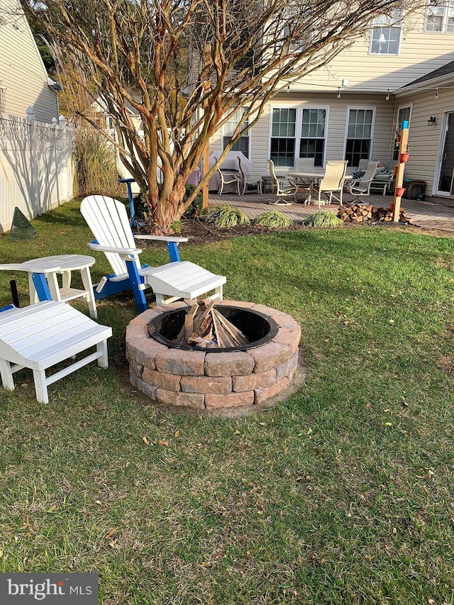 view of yard with an outdoor fire pit and a patio area