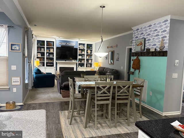 dining room with dark hardwood / wood-style flooring and crown molding