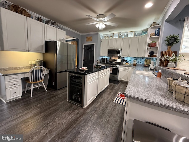 kitchen with ceiling fan, stainless steel appliances, ornamental molding, white cabinets, and sink