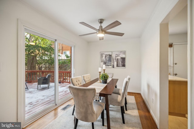 dining area with ceiling fan and wood-type flooring