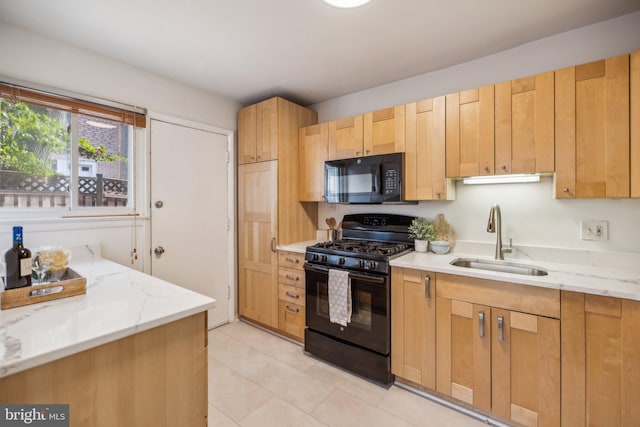 kitchen with sink, light brown cabinets, black appliances, and light stone counters