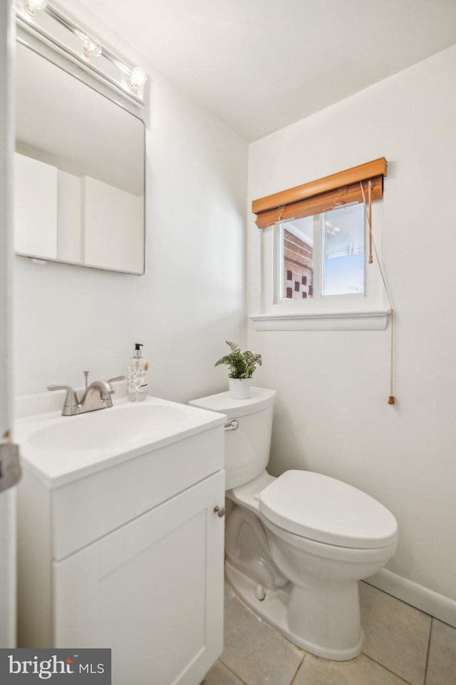 bathroom featuring vanity, toilet, and tile patterned floors