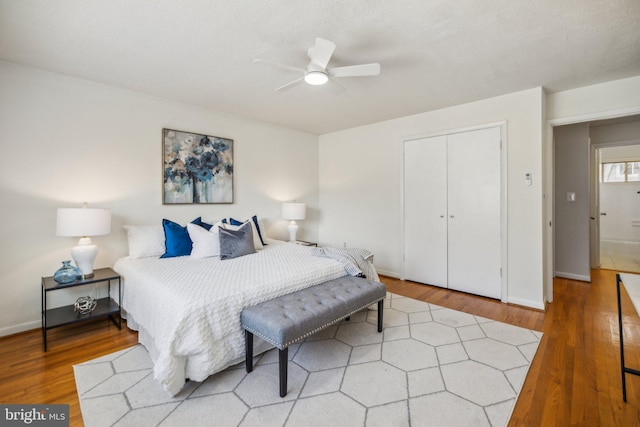 bedroom with a closet, ceiling fan, and wood-type flooring