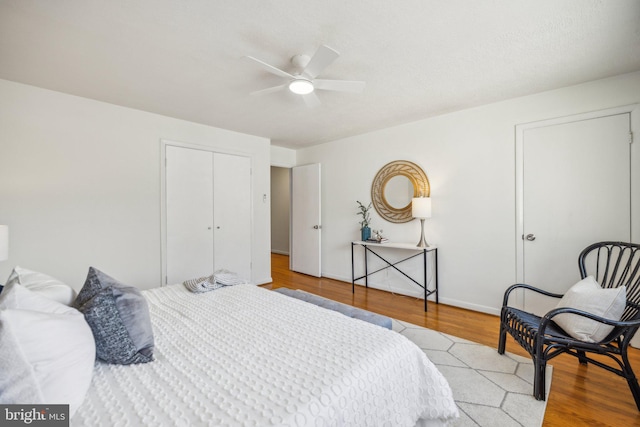 bedroom featuring a closet, ceiling fan, and light wood-type flooring