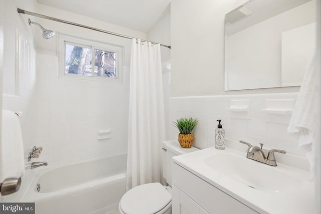 full bathroom with vanity, backsplash, tile walls, toilet, and shower / bath combo with shower curtain