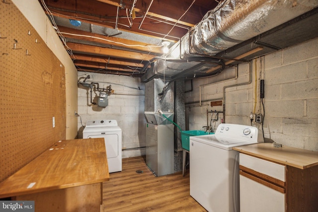 clothes washing area with washer and dryer, sink, and heating unit