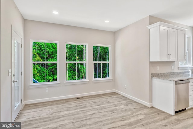 unfurnished dining area with light wood-type flooring