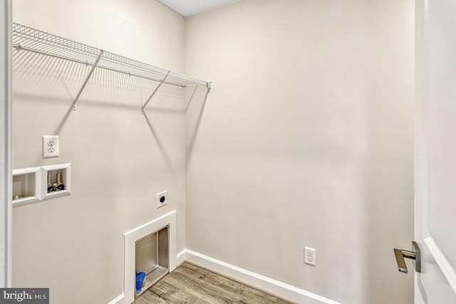 laundry room featuring washer hookup, hardwood / wood-style flooring, and electric dryer hookup