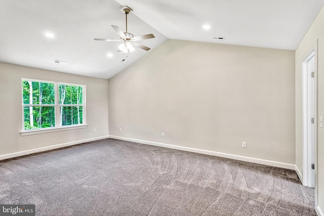 carpeted spare room featuring ceiling fan and lofted ceiling