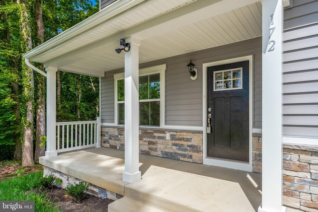 entrance to property featuring a porch