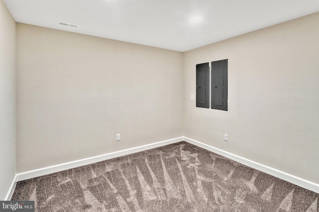 empty room featuring electric panel and carpet floors