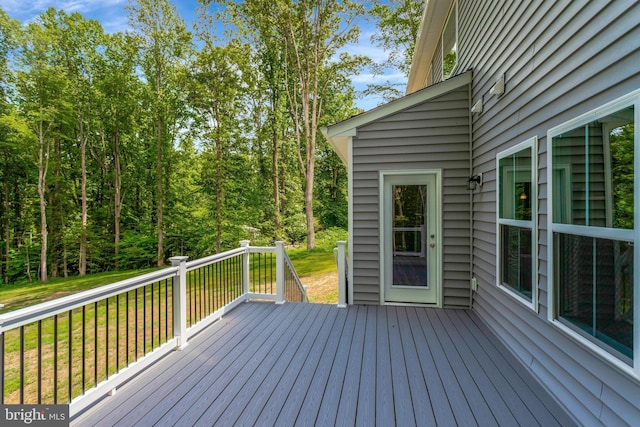 wooden deck featuring a yard