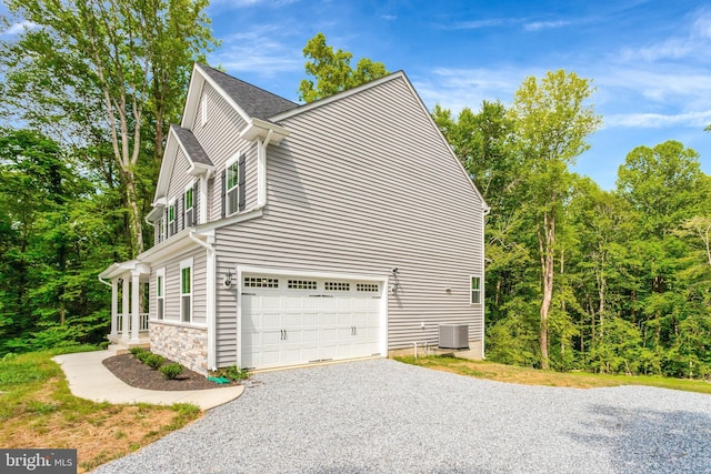 view of side of home with cooling unit and a garage