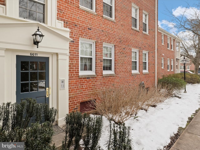 view of snow covered property entrance