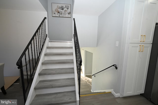 stairway with hardwood / wood-style floors