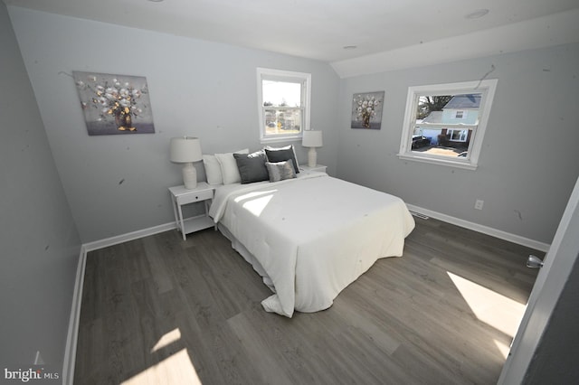 bedroom featuring dark hardwood / wood-style flooring and vaulted ceiling