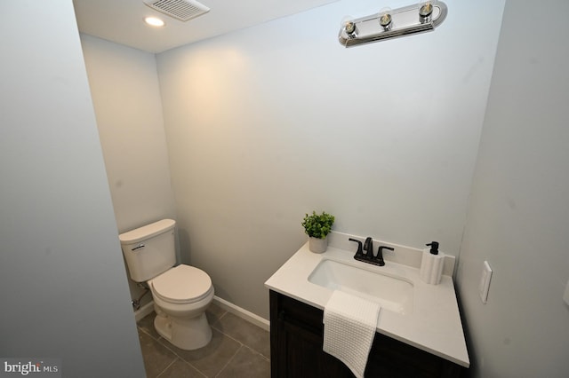 bathroom featuring tile patterned floors, vanity, and toilet