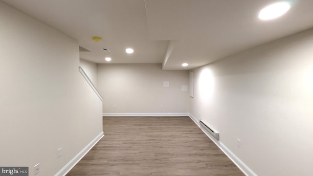 basement with baseboard heating and wood-type flooring