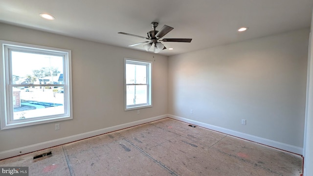 spare room featuring ceiling fan and a healthy amount of sunlight