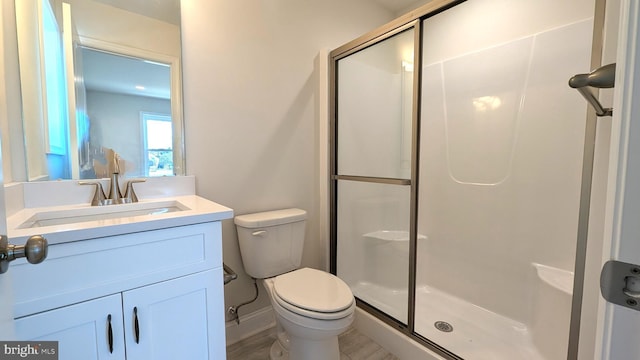 bathroom featuring vanity, toilet, and walk in shower