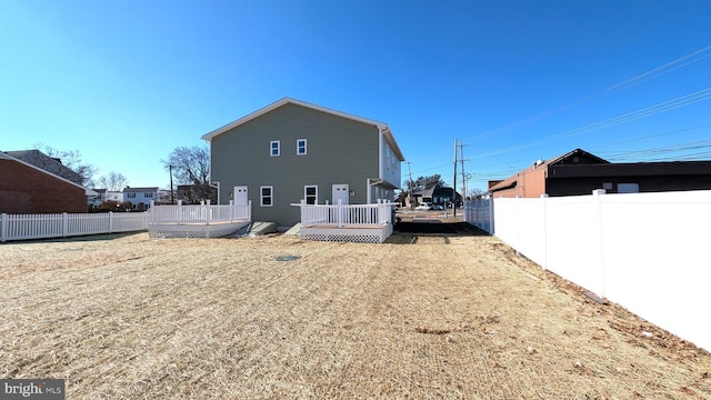 back of property with a wooden deck