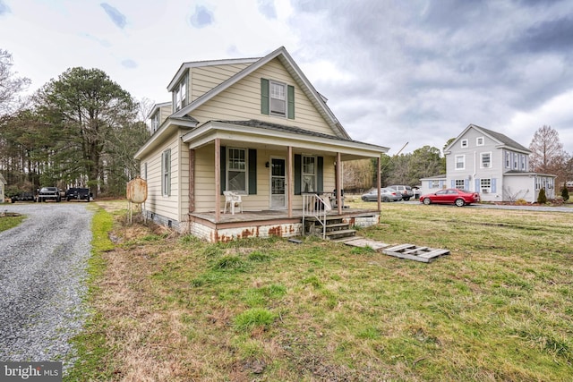 view of front facade with a front yard and a porch