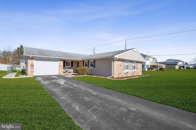 ranch-style house featuring a garage and a front lawn