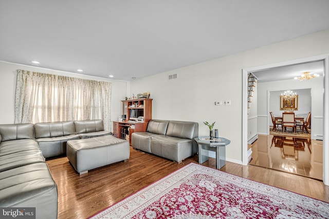 living room featuring hardwood / wood-style floors and a notable chandelier