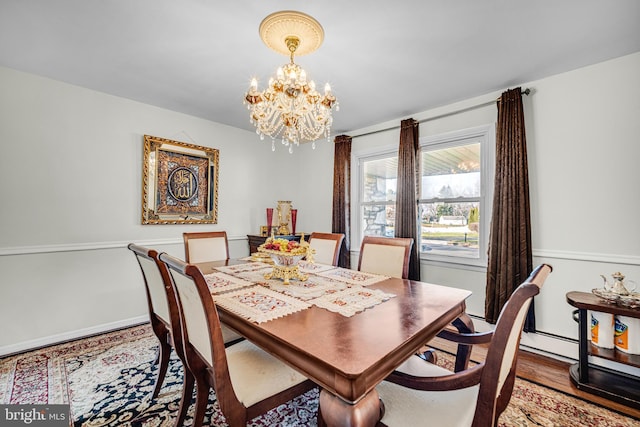 dining room featuring hardwood / wood-style floors and a chandelier